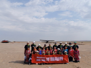 当日参加した、モンゴル族第一小学校の2年生とNPOグリーングラスロッツのみなさん。後方に見えるが、播種に使った飛行機